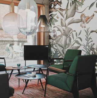 Apotheke White Vetiver Candle Mood forest green armchairs in a cafe with plants wallpaper and coffee tables